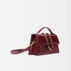 El bolso grande con solapa metálica Bambino Cross-body El bolso grande con solapa metálica Bambino Cross-body