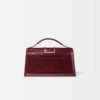El bolso grande con solapa metálica Bambino Cross-body El bolso grande con solapa metálica Bambino Cross-body