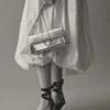 El bolso largo Bambino Bolso largo con solapa metálica